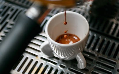Put your coffee into the Nespresso machine and press the button